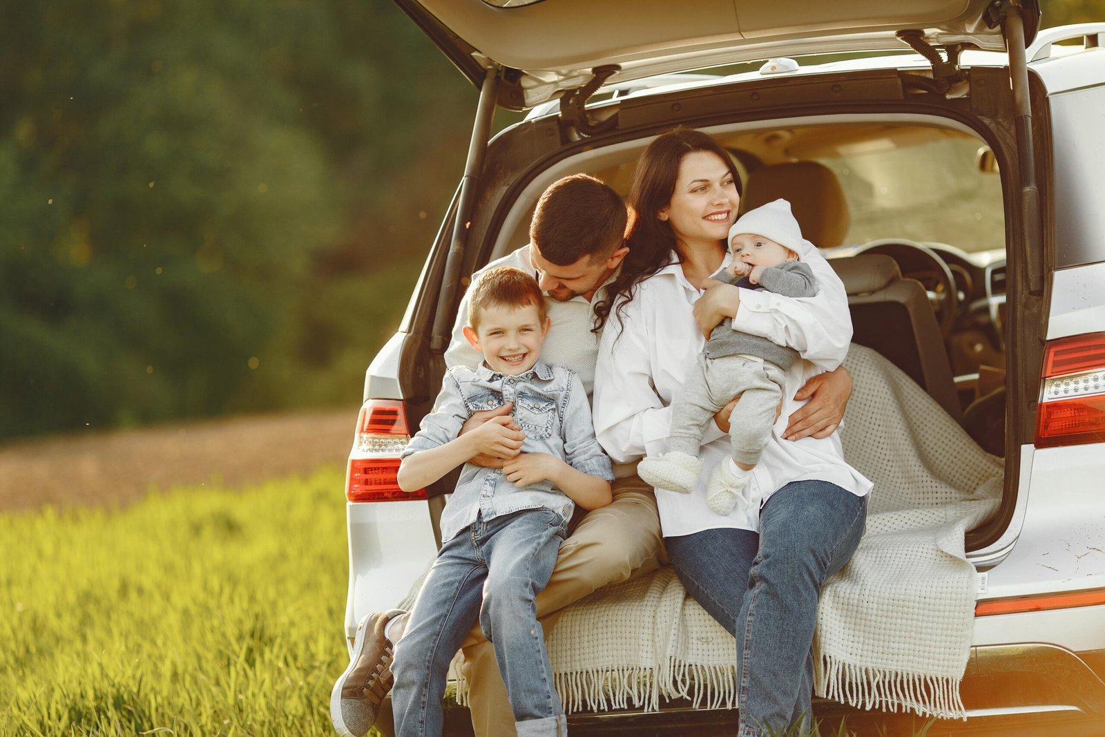 family-summer-forest-by-open-trunk