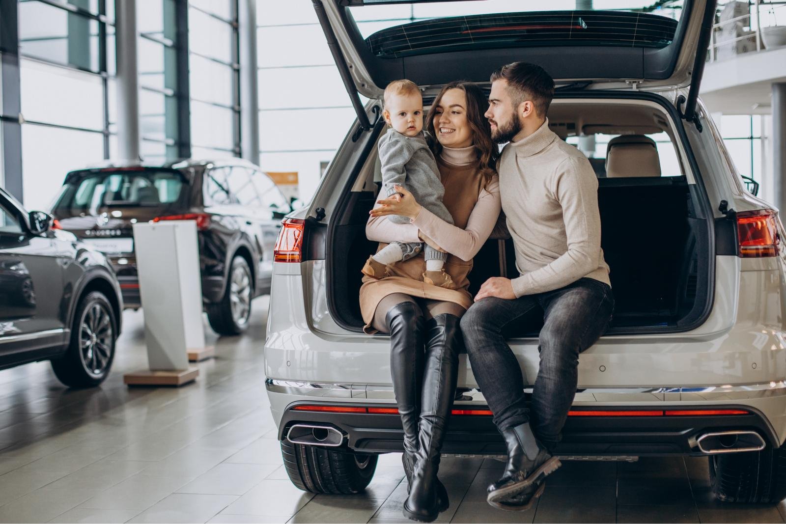 family-with-toddler-girl-choosing-car-car-showroom