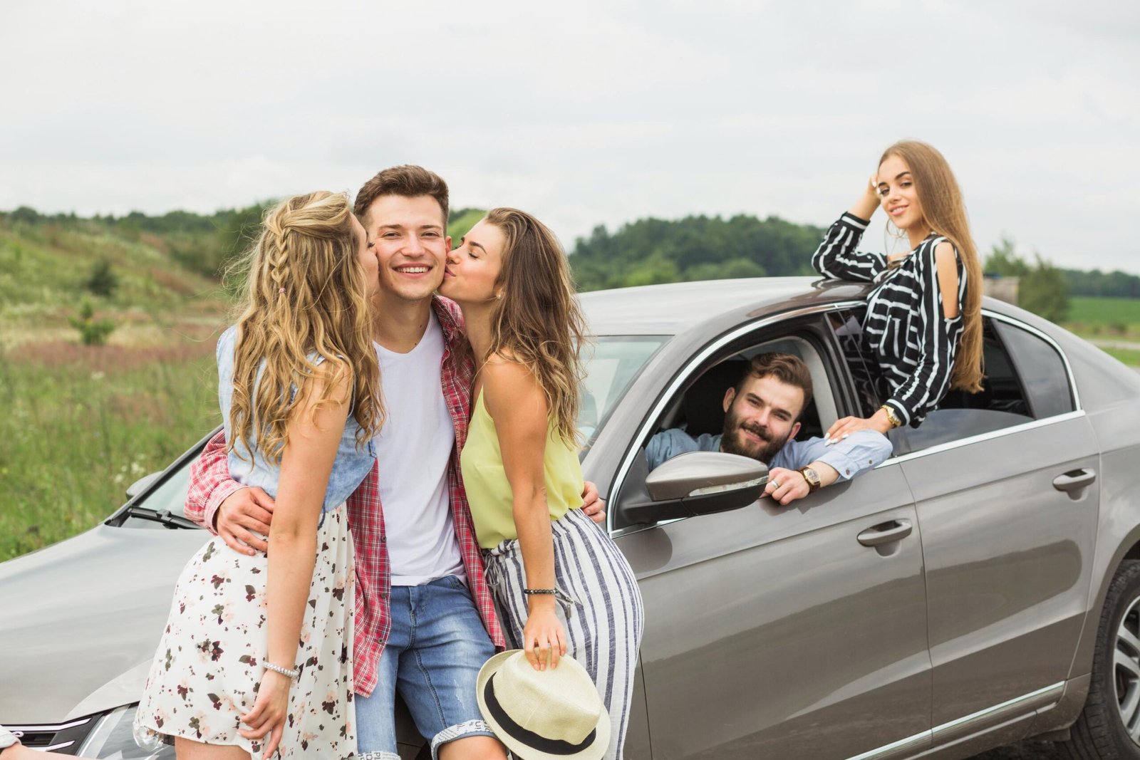 two-girls-kissing-her-boyfriend-standing-near-car