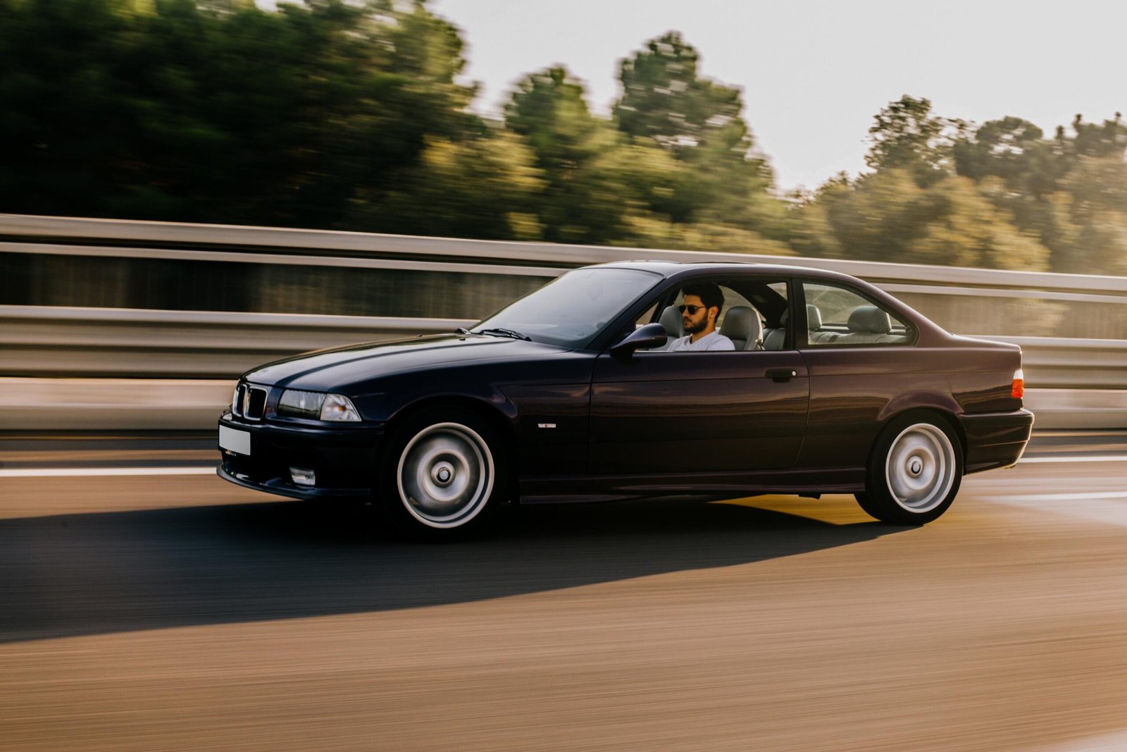 vintage-sedan-car-driving-highway-side-view